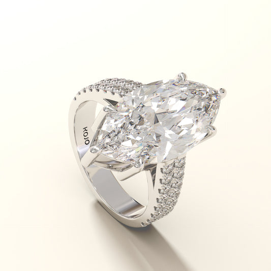 Diamond ring with a large central gemstone and smaller stones on a white background