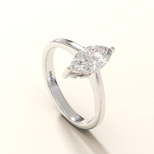 Angled view of marquise-cut solitaire diamond ring with minimal band.