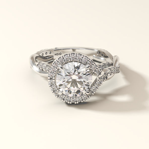 A brilliant 2 carat round-cut diamond ring in white gold, encircled by a radiant halo.