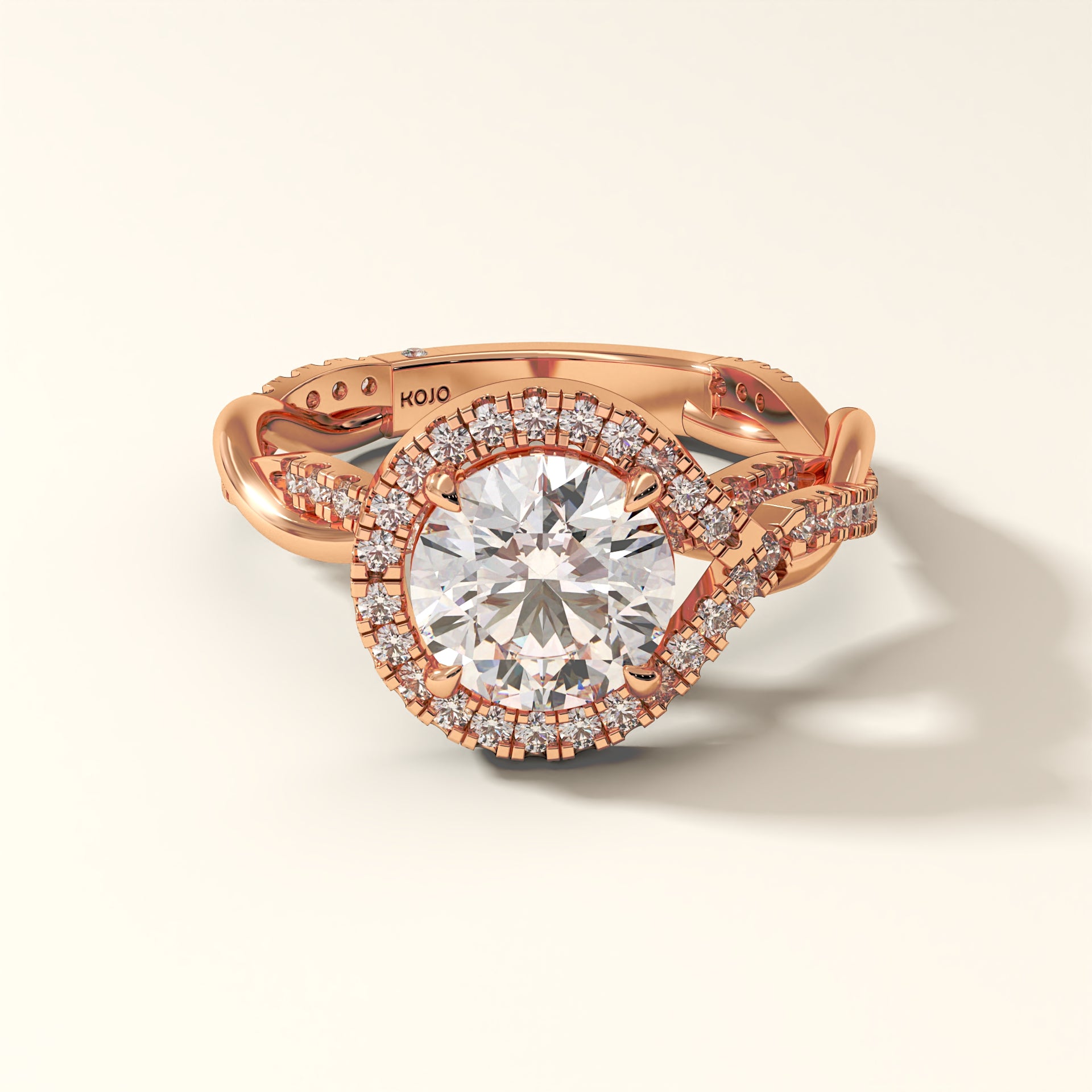 A brilliant 2 carat round-cut diamond ring in rose gold, encircled by a radiant halo.