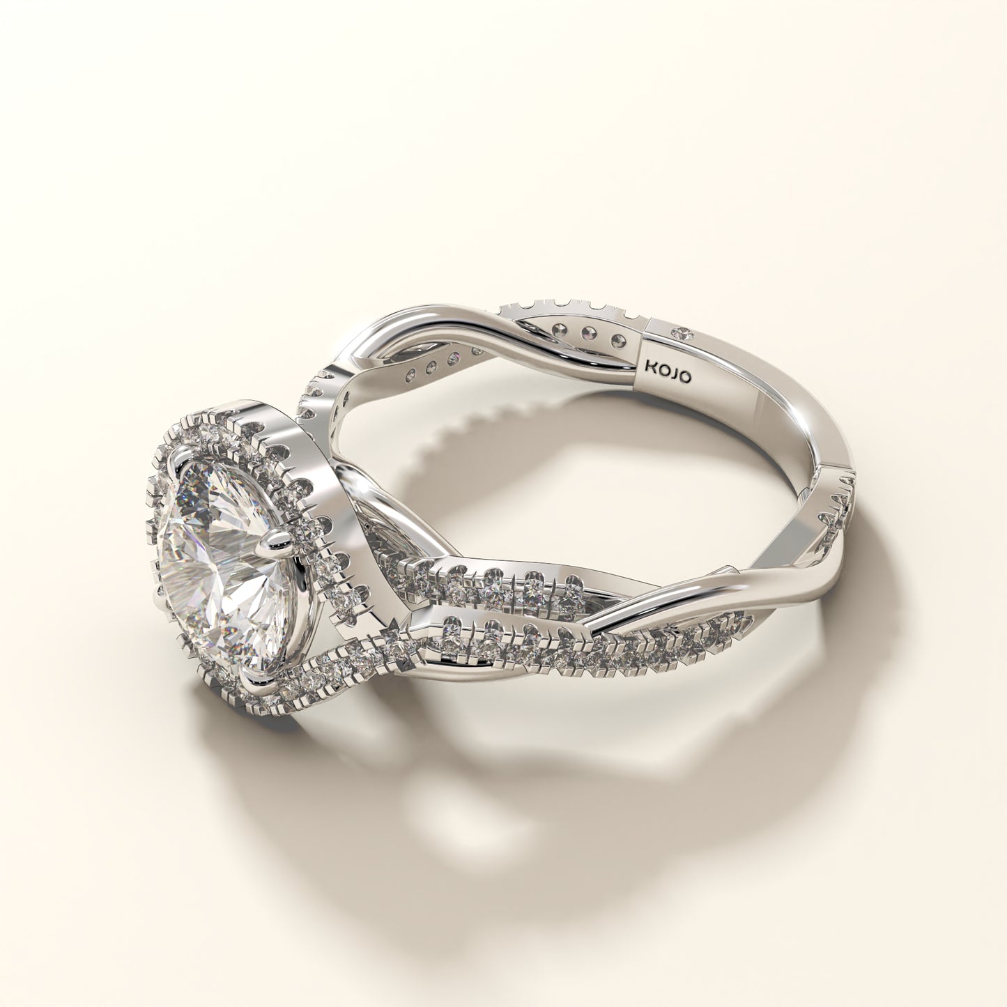 A 2CT round-cut lab grown diamond ring in white gold, surrounded by a halo and a twisted shank.