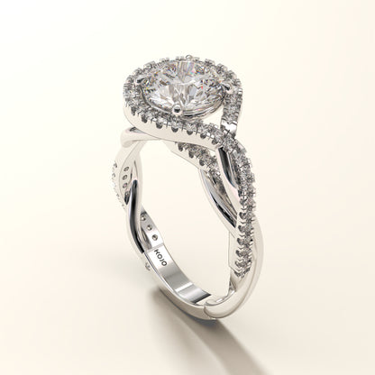 A round-cut 2CT diamond ring, surrounded by a halo in white gold on a light background.