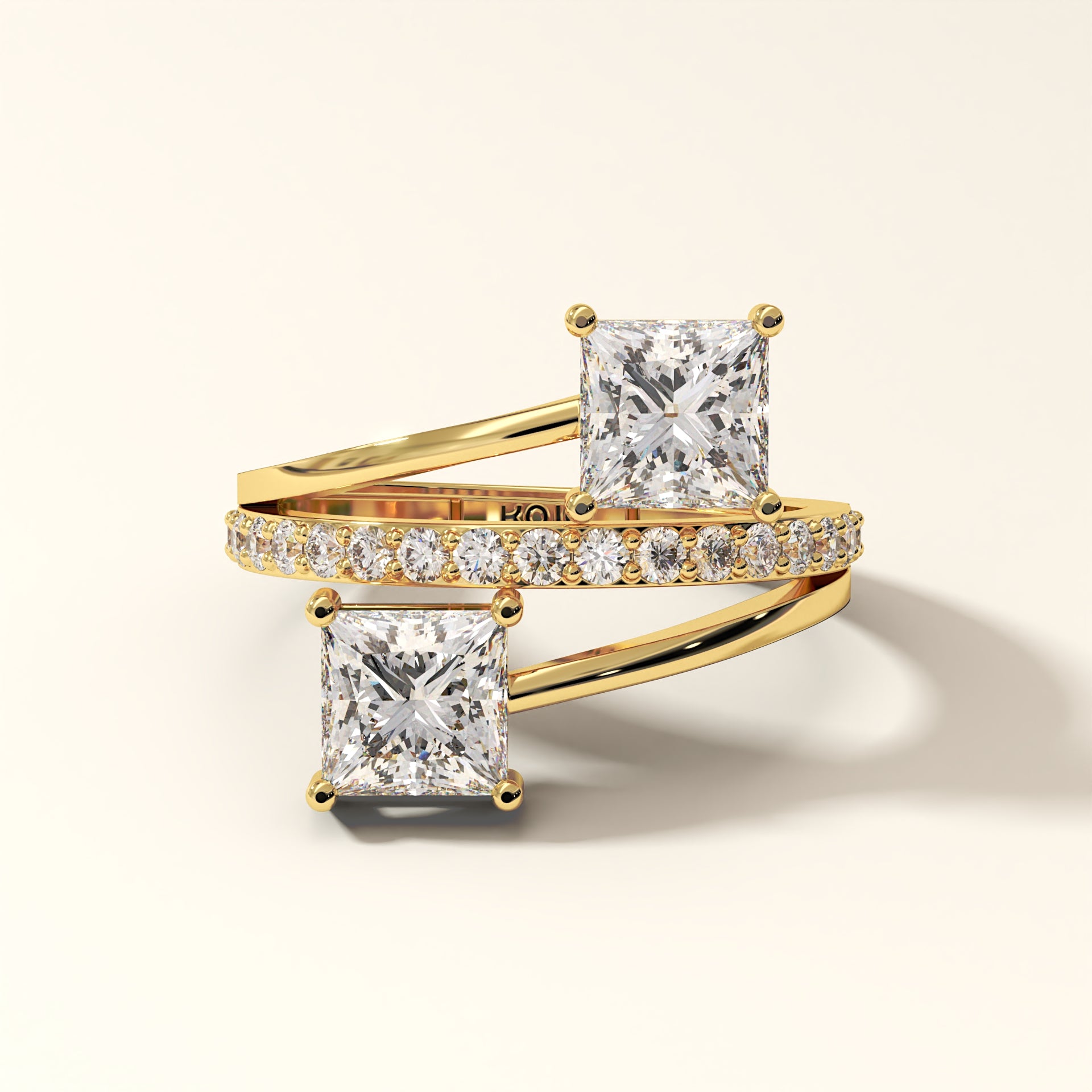 Prism Arc - 2 Princess Cut Diamond Ring with 17 Round Pavé Diamonds in 18K Yellow Gold. Total diamond 2.36 Carat with princess-cut stones on a light background with "KOJO" branding (front-view).