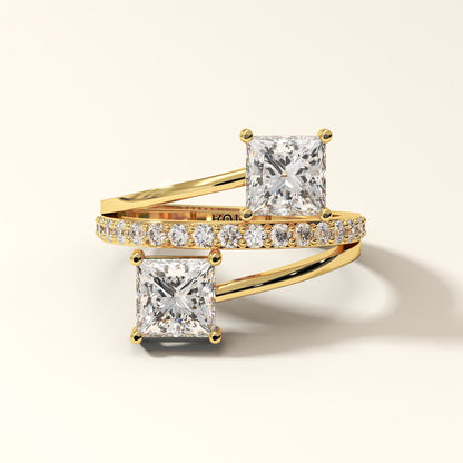 Prism Arc - 2 Princess Cut Diamond Ring with 17 Round Pavé Diamonds in 18K Yellow Gold. Total diamond 2.36 Carat with princess-cut stones on a light background with "KOJO" branding (front-view).