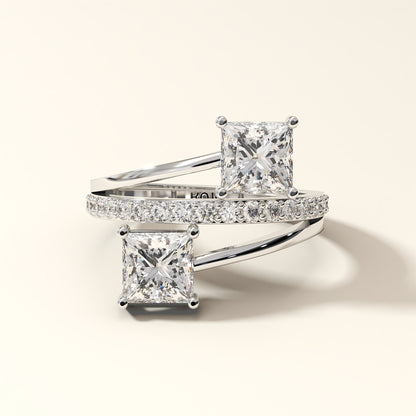 Prism Arc - 2 Princess Cut Diamond Ring with 17 Round Pavé Diamonds in 18K White Gold. Total diamond 2.36 Carat with princess-cut stones on a light background.