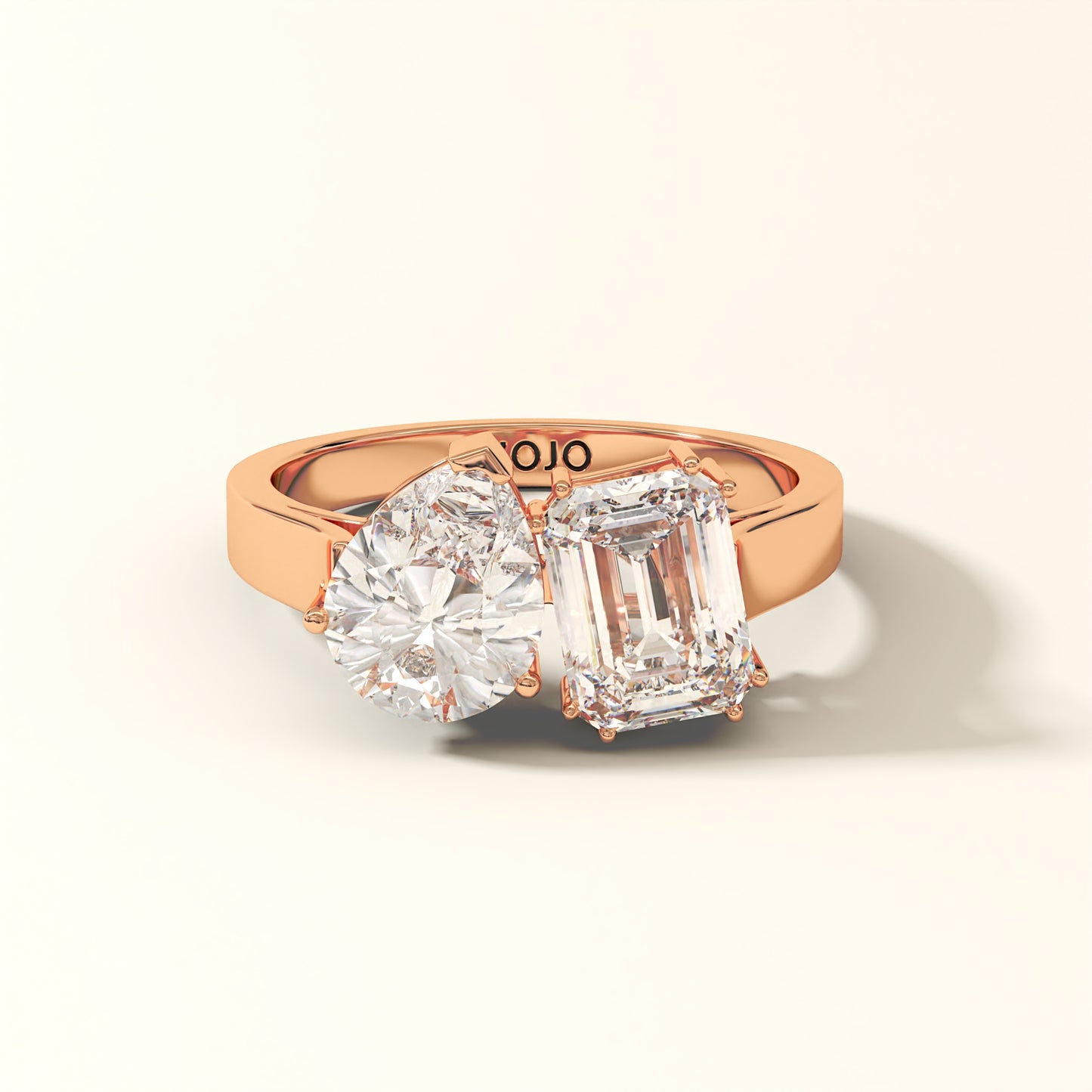 Duet Line - 3 Carat Emerald-cut diamond and Pear-cut Lab-Grown Diamond Ring in 18K Rose Gold with 'KOJO' branding on a light beige background.