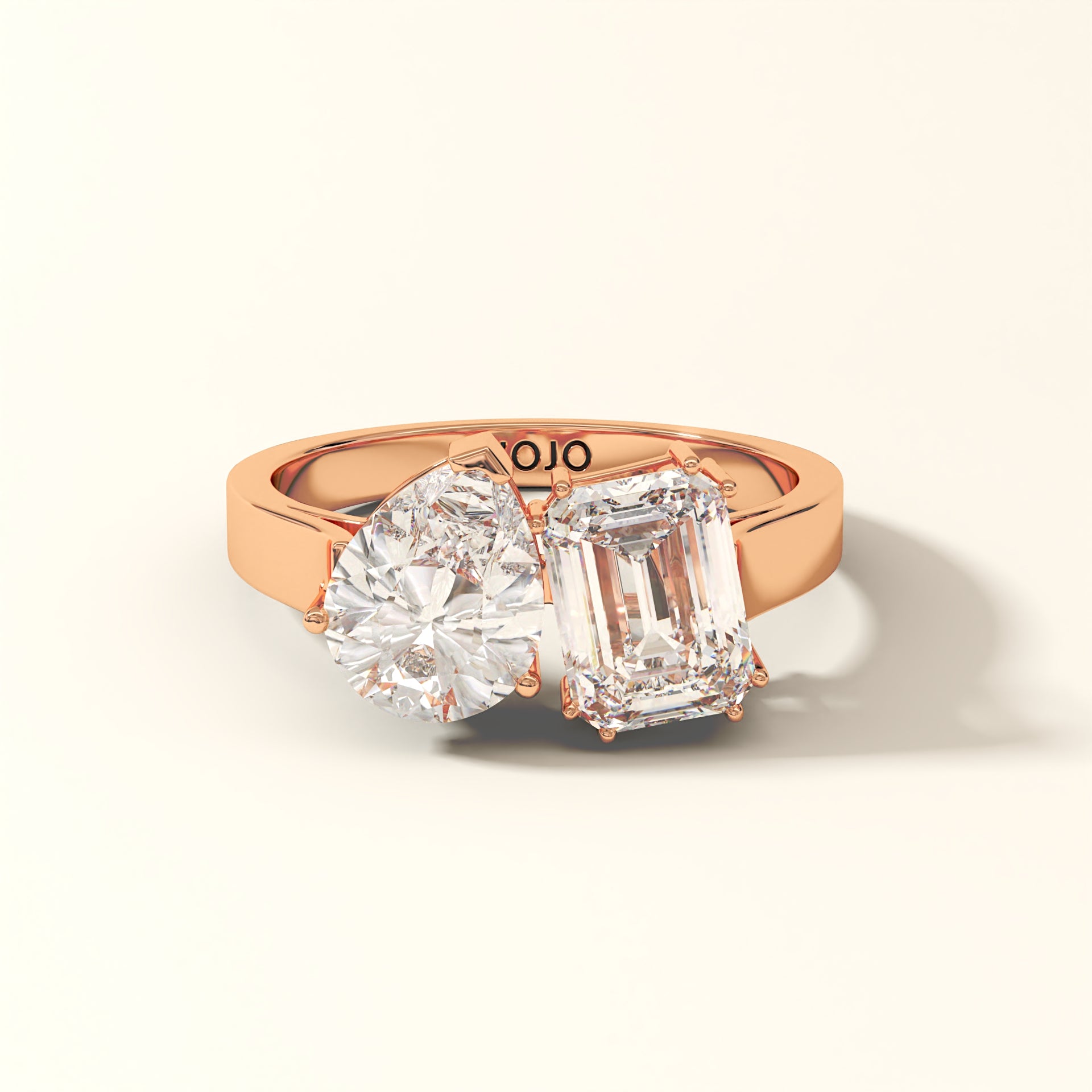 Duet Line - 3 Carat Emerald-cut diamond and Pear-cut Lab-Grown Diamond Ring in 18K Rose Gold with 'KOJO' branding on a light beige background.