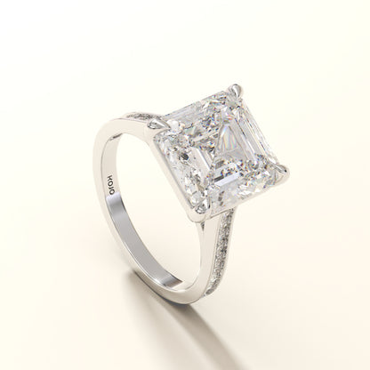 Diamond ring with a large asscher diamond and smaller round diamonds on the band 