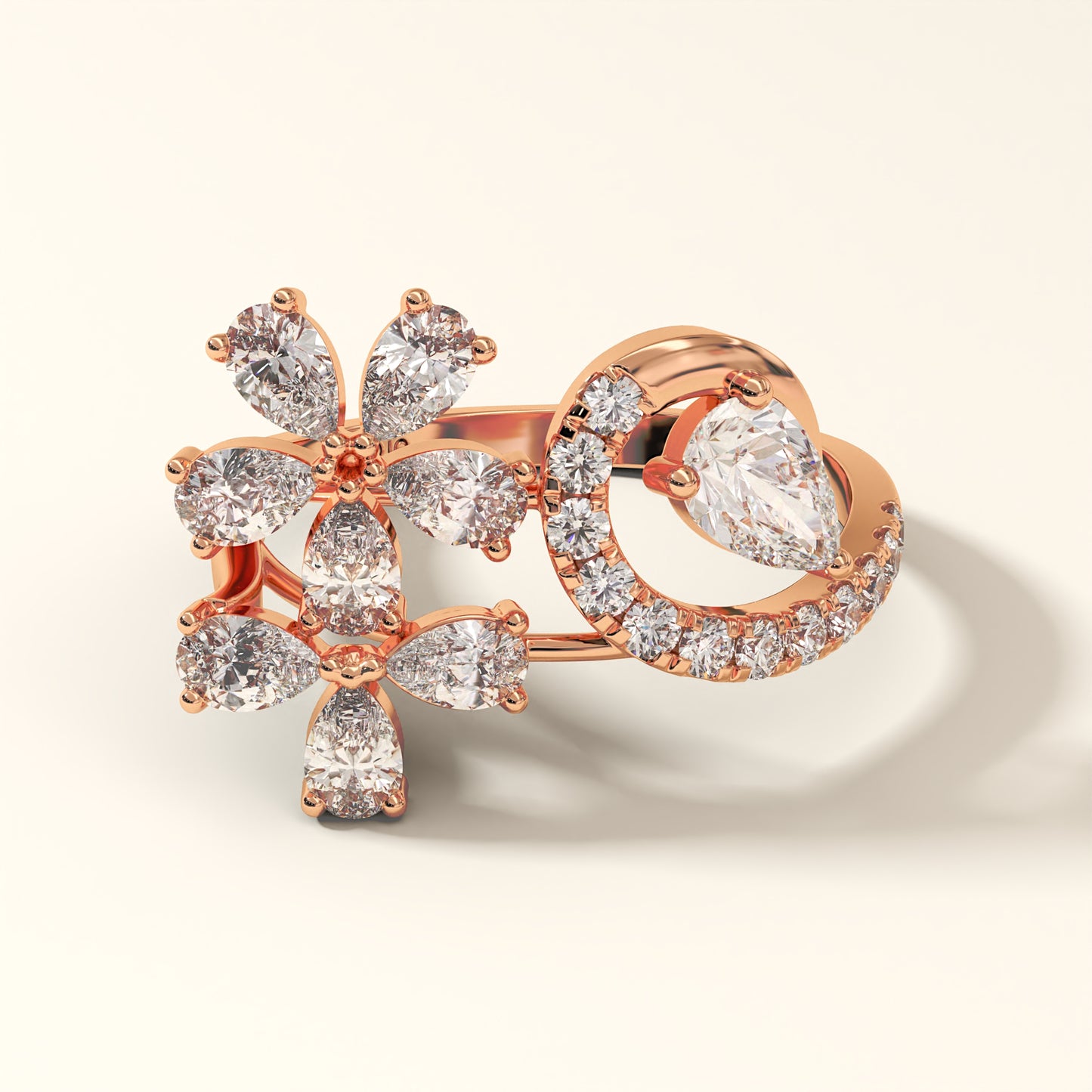 A rose gold floral design 2.13 Carat Pear Cut Diamond Ring with 8 Pear-Cut Diamonds, 1 Pear-Cut Diamond and 12 Pavé Round Diamonds in 18K rose gold. Celestine Flora Rose gold ring with diamond accents on a light beige background (front-view).