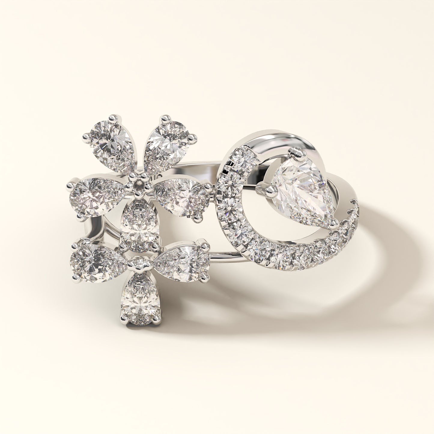 A floral design 2.13 Carat Pear Cut Diamond Ring with 8 Pear-Cut Diamonds, 1 Pear-Cut Diamond and 12 Pavé Round Diamonds in 18K white gold. Celestine Flora Diamond ring with floral design on a light background.