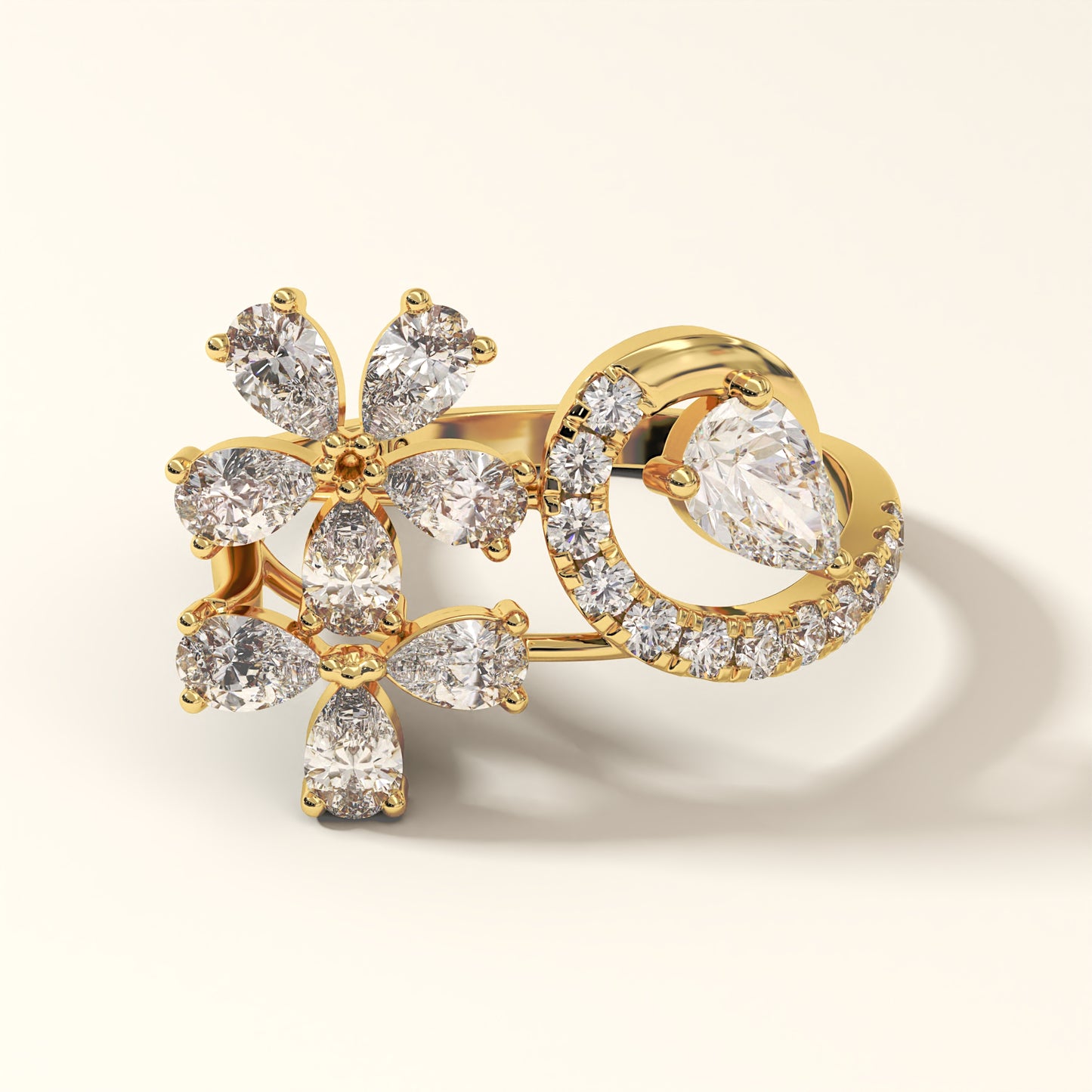A stunning floral design 2.13 Carat Pear Cut Diamond Ring with 8 Pear-Cut Diamonds, 1 Pear-Cut Diamond and 12 Pavé Round Diamonds in 18K yellow gold. Celestine Flora Diamond ring on a light background (front-view).