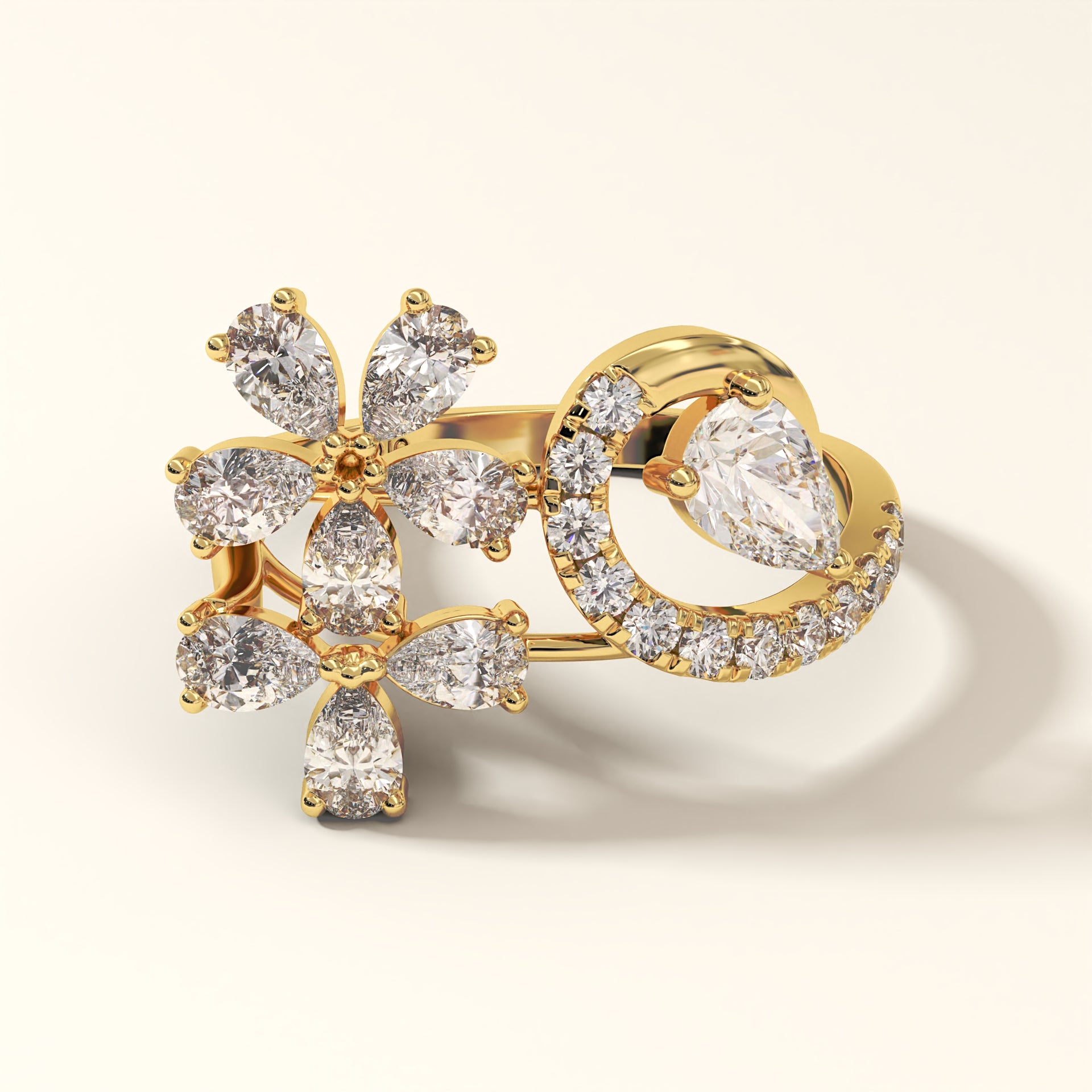 A stunning floral design 2.13 Carat Pear Cut Diamond Ring with 8 Pear-Cut Diamonds, 1 Pear-Cut Diamond and 12 Pavé Round Diamonds in 18K yellow gold. Celestine Flora Diamond ring on a light background (front-view).