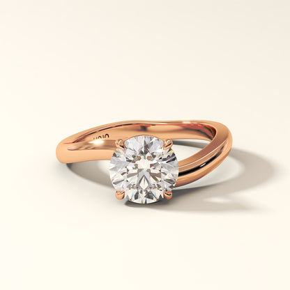 1.50 Carat Round Brilliant Diamond Ring in Rose gold with "KOJO" Diamonds branding on a light beige background. The Solara Arc Diamond Ring displayed with front-view.