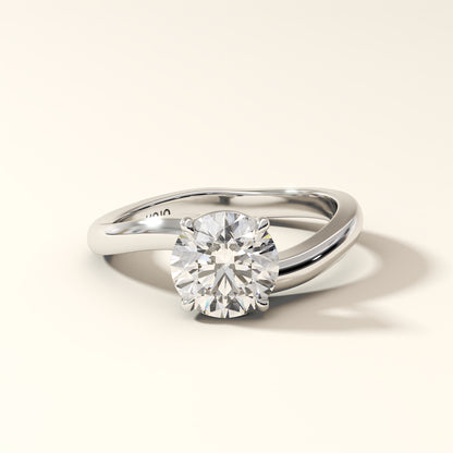 Solara Arc - 1.50 Carat Round Brilliant Diamond Ring in white gold with "KOJO" Diamonds branding on a light beige background (front view).