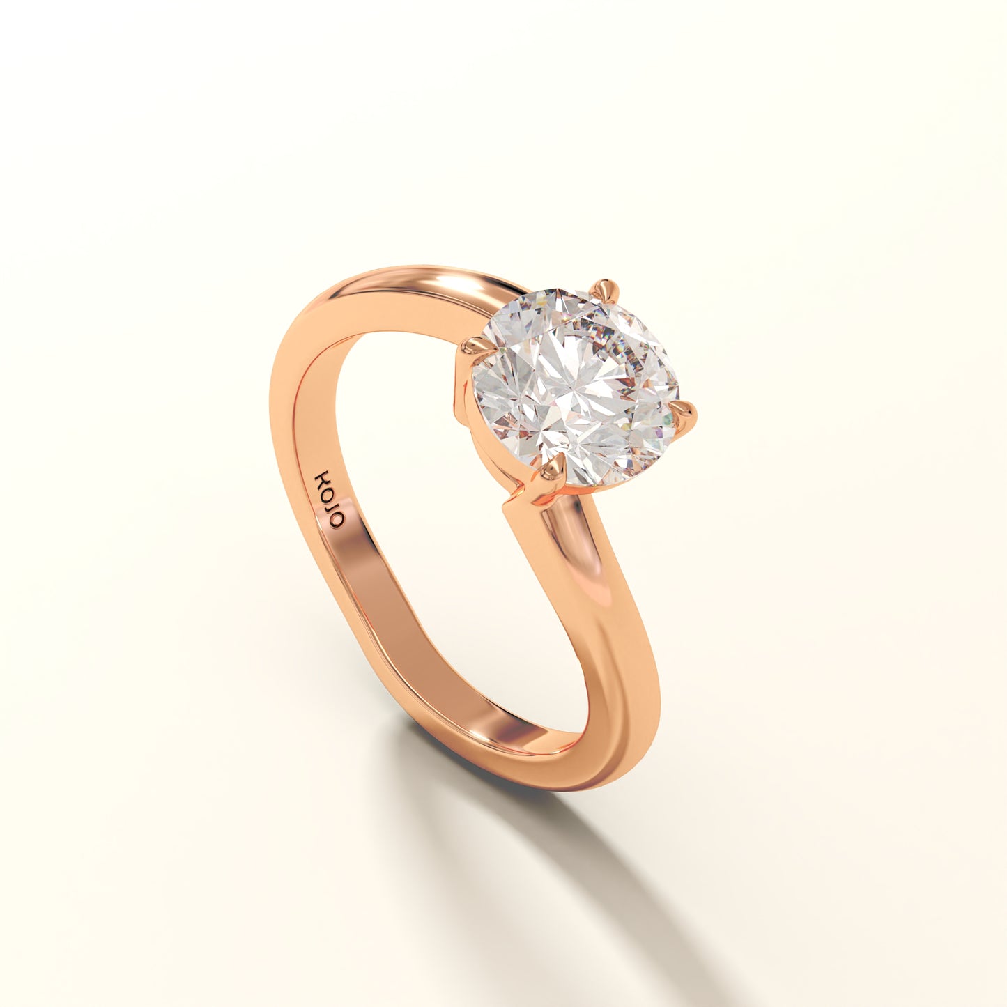 Rose gold ring with a diamond on a white background with KOJO branding.