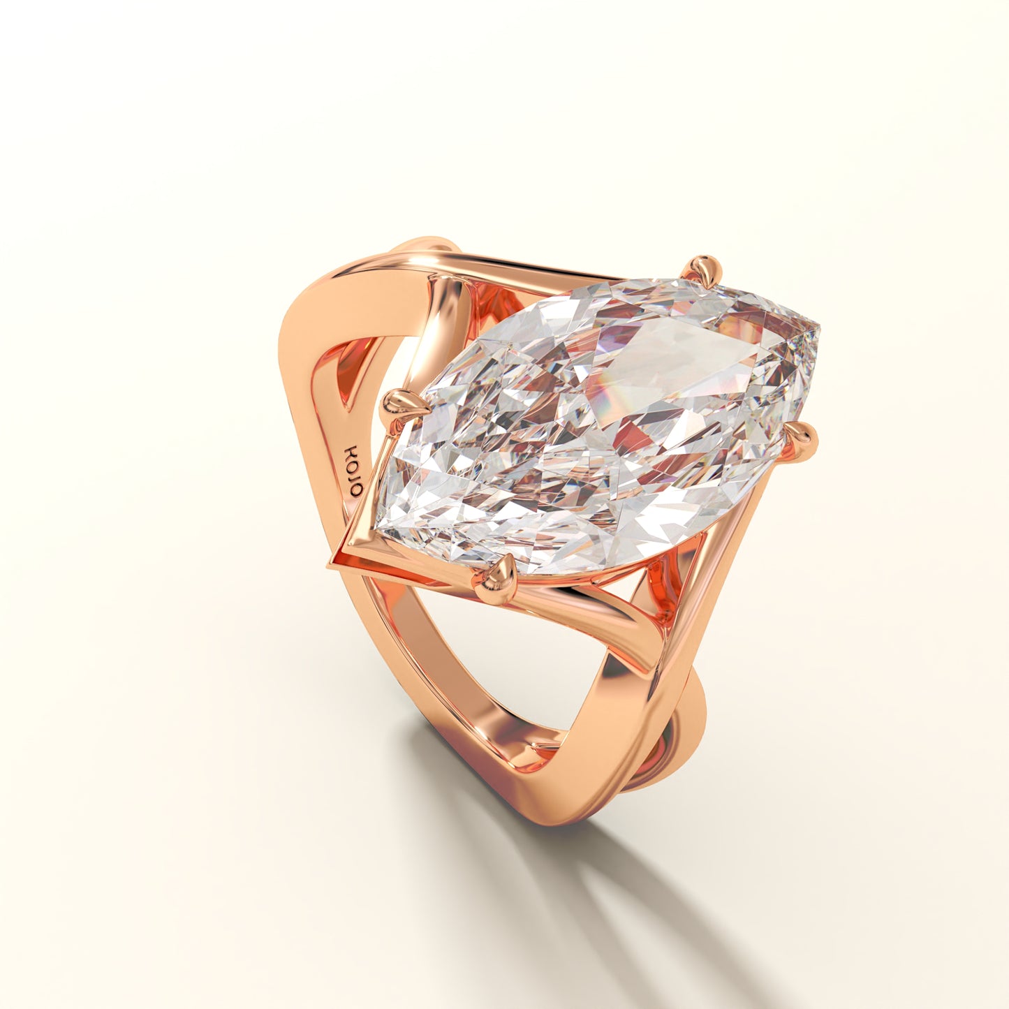 Rose gold ring with a large marquise-shaped diamond on a light background