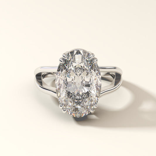 Diamond ring with a large oval-cut gemstone in white gold on a light background.