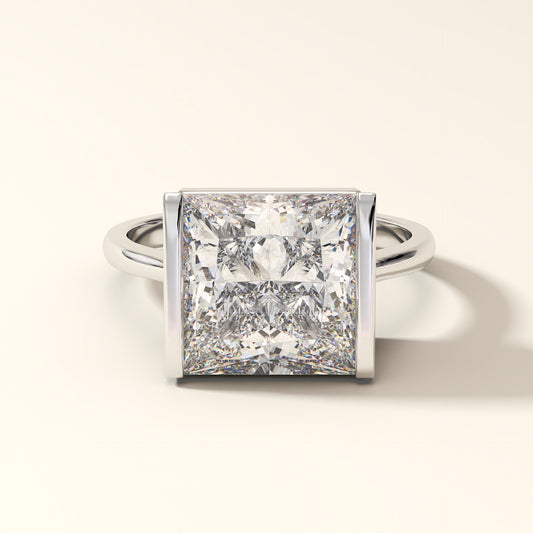 Princess-cut diamond engagement ring with bezel setting in white gold.