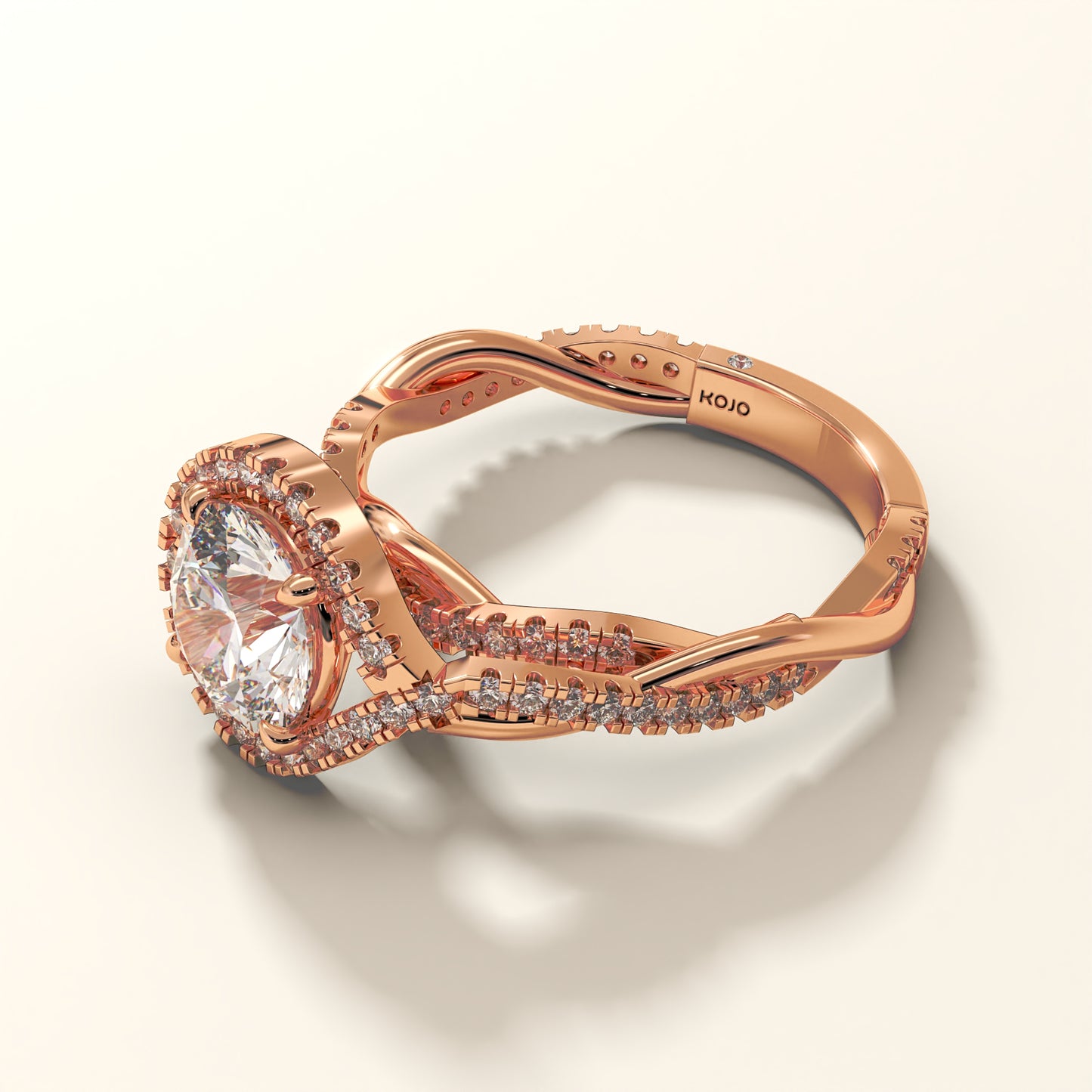 A 2 carat round-cut halo twist diamond ring in rose gold, with a twisted shank.