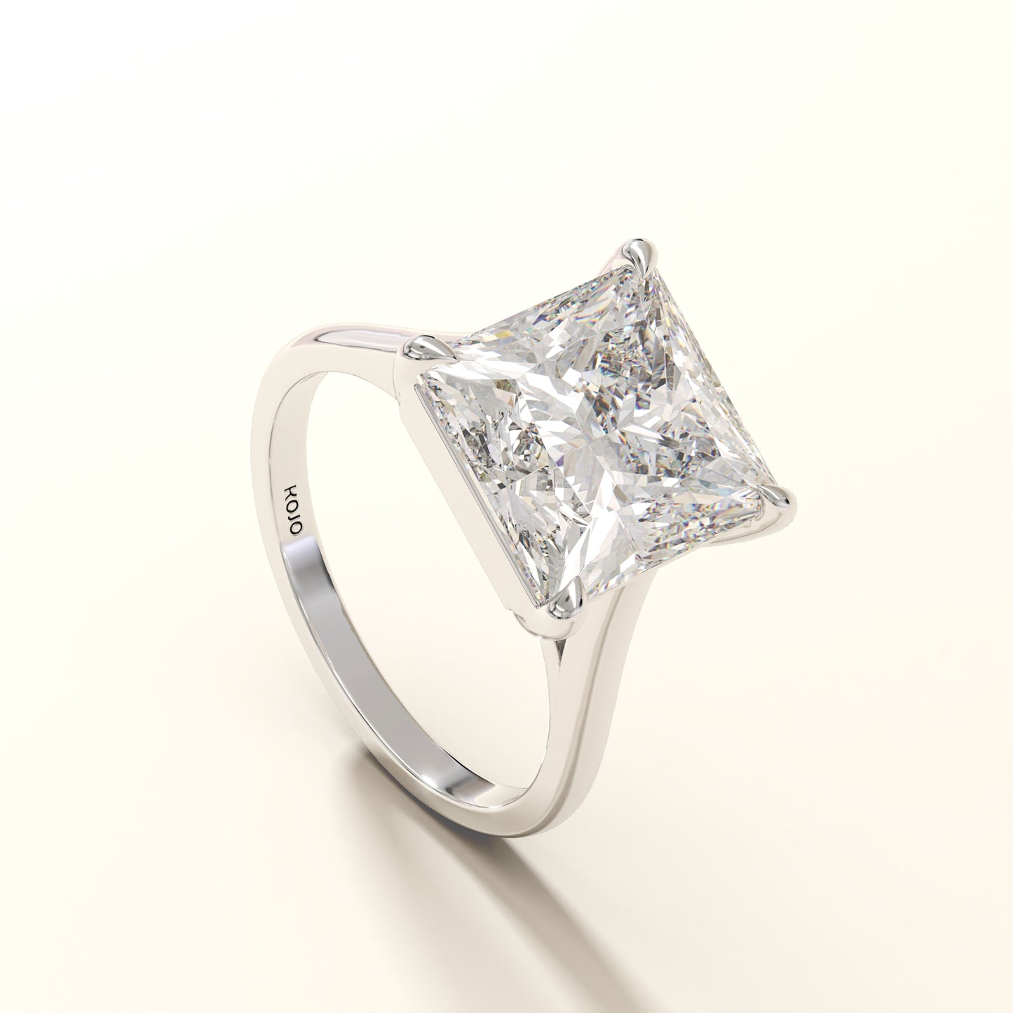 Diamond ring with a princess cut diamond on a white background