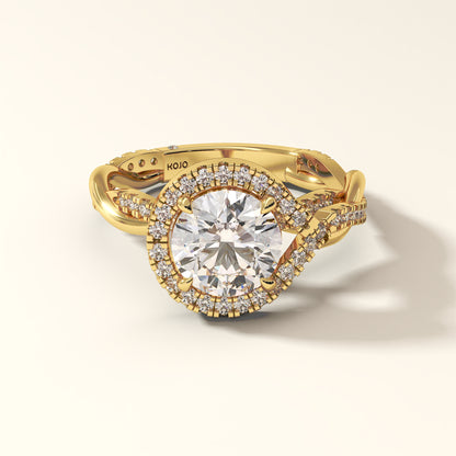 2 carat round-cut lab grown diamond ring in yellow gold, encircled by a radiant halo and a twisted shank.