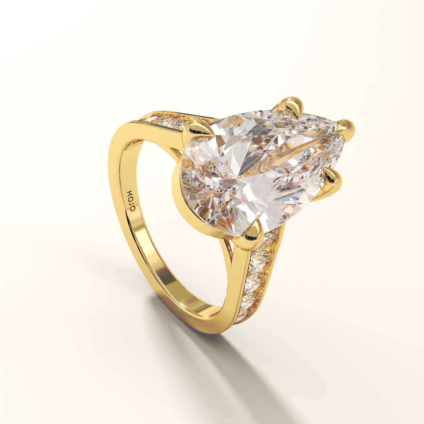 Yellow gold ring with a large pear cut diamond and smaller round diamonds on the band