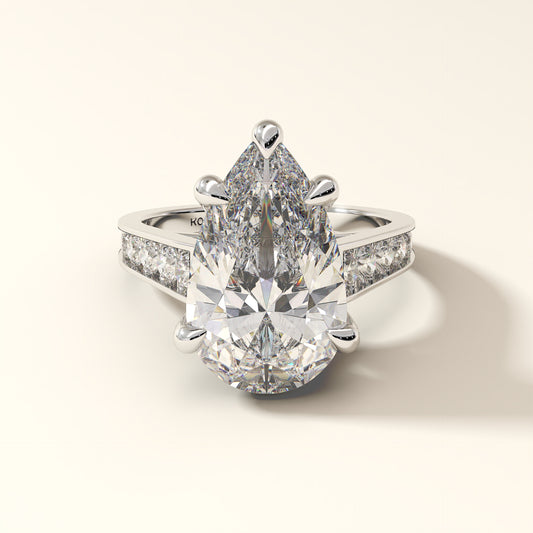 Celestial Verge pear cut lab grown diamond solitaire ring with pave band in 18K gold